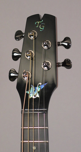 Photo of the headstock of Mandonator 11, showing the two inlays 