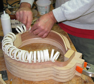 Photo showing lining for the sideframe being glued and clamped with O-rings